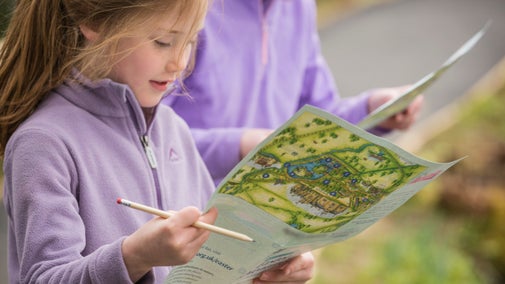 Image of two girls completing their Easter trail sheets